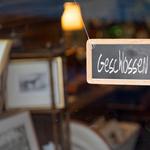 German closed sign.Writting slate hanging at the entrance of a shop saying in German "Geschlossen", meaning in English "Closed".