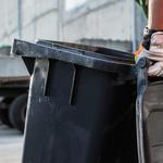 Garbage Truck Worker Moving Trash Can