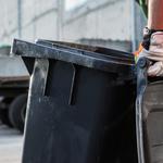 Garbage Truck Worker Moving Trash Can