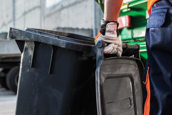 Garbage Truck Worker Moving Trash Can