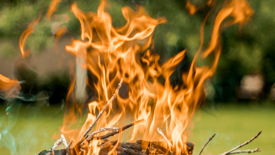 Bild mit Flammen. Verbrennen von Gartenabfall.